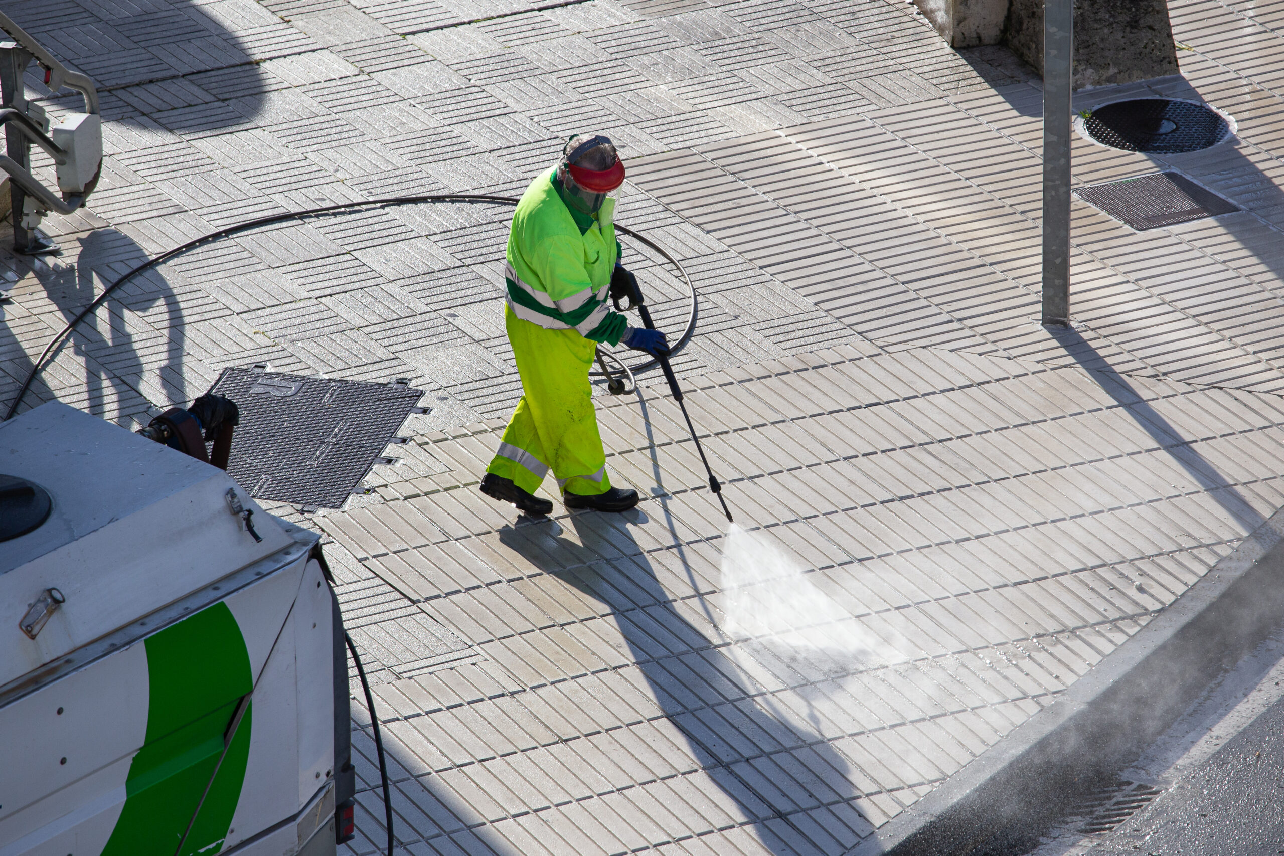 worker cleaning a sidewalk with high pressure wate 2023 11 27 05 22 58 utc 1 scaled